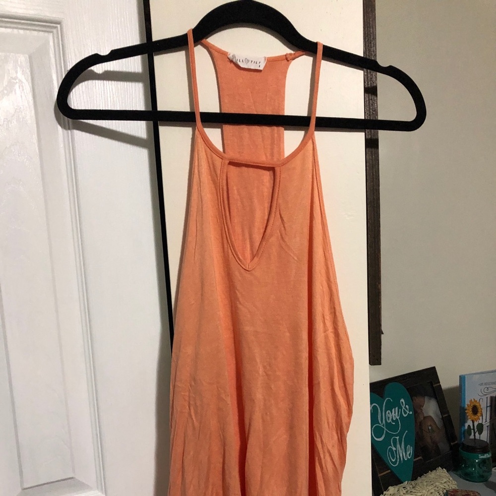 Orange tank top. Open back. Key hole in the front